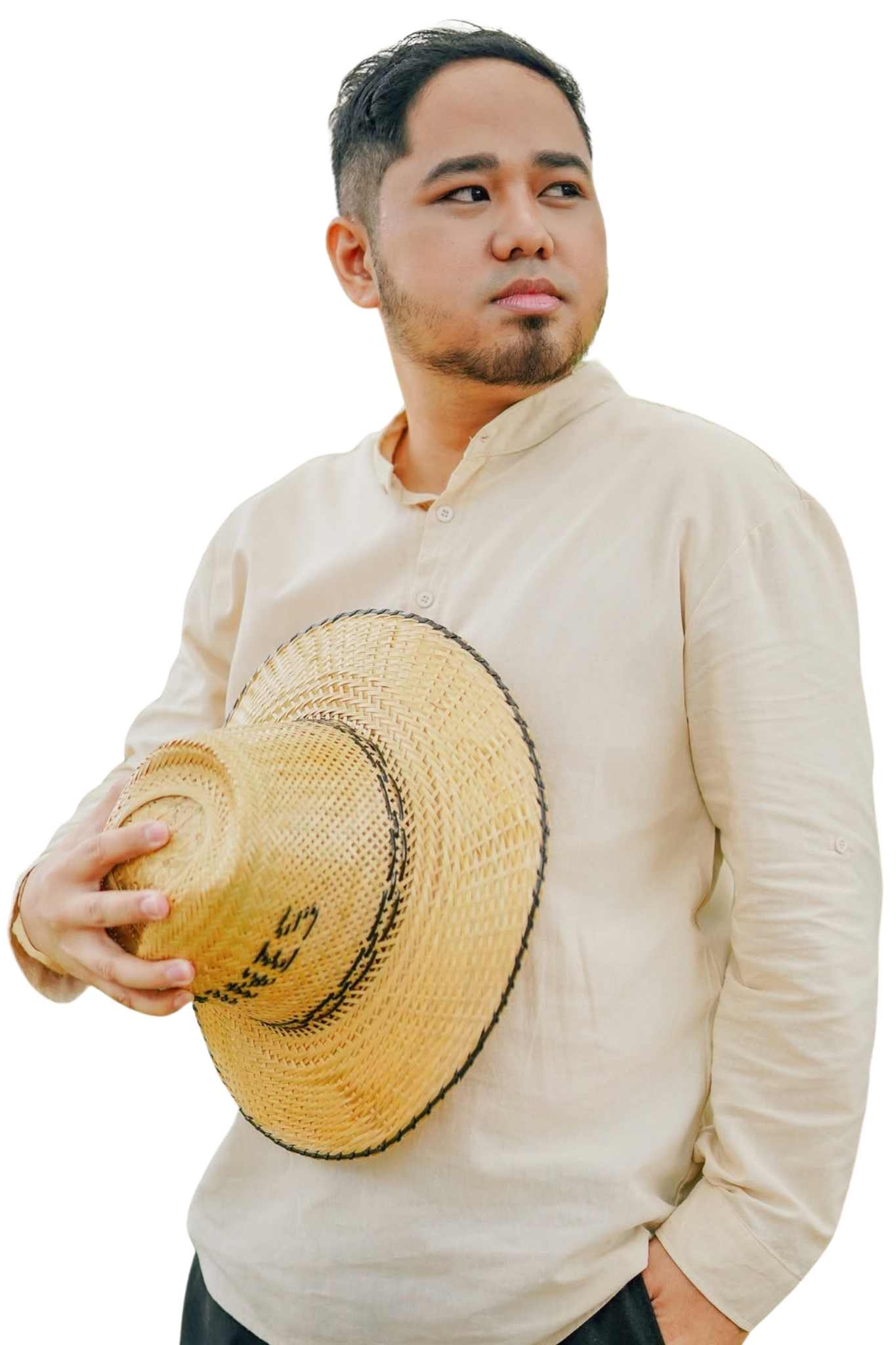 Clent Mendelebar outdoors, holding a woven hat